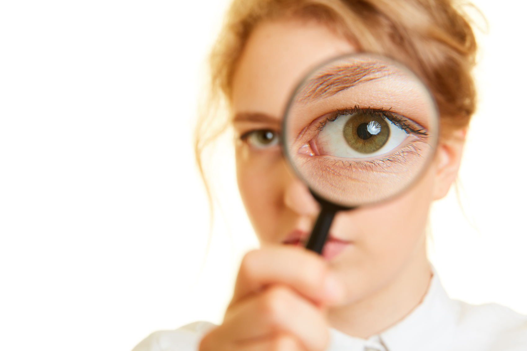 Woman Looks with Eye through Magnifying Glass as a Control Conce